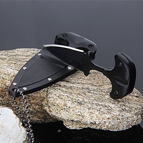 Black knife with sheath on a rock